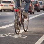 Person Biking Safely in Bike Lane on Road